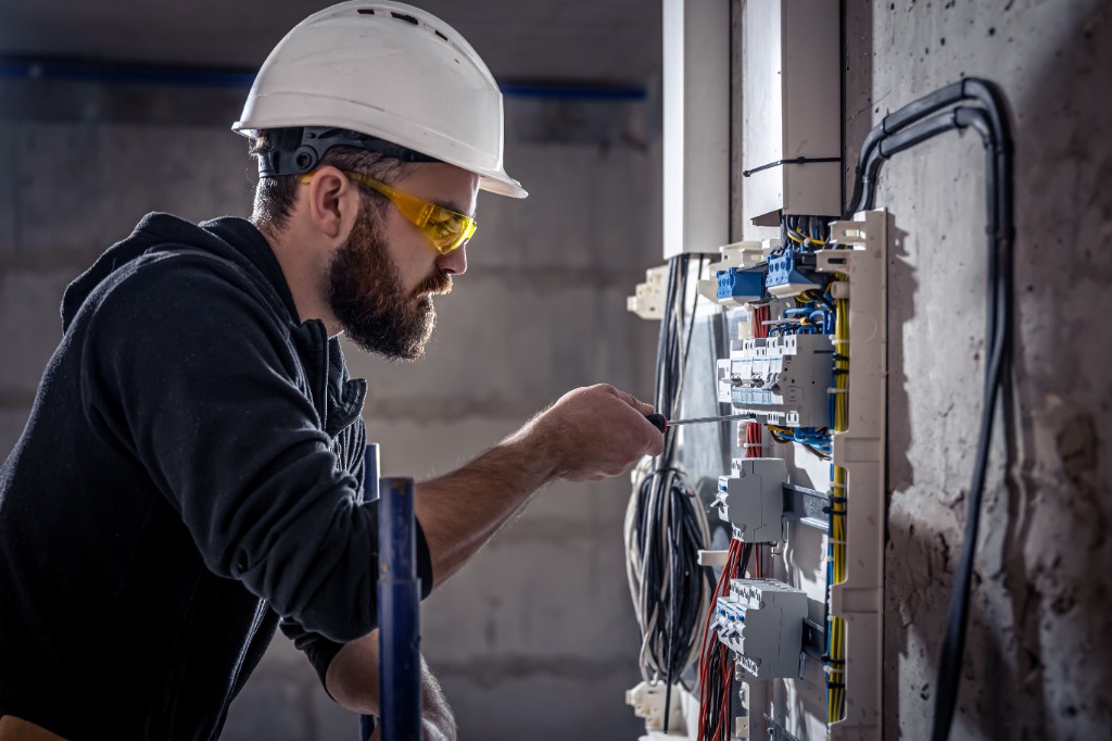 Electrician working on electrical panel